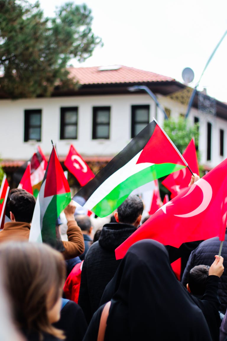 Asia: The Cradle of Civilization, Culture, and DiversityA vibrant street protest featuring Palestinian and Turkish flags held by diverse crowd.