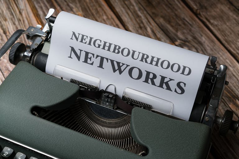 SeaIsleNews: Your Complete Guide to Local News, Community Updates, and Coastal LifeA vintage typewriter displaying the text 'Neighbourhood Networks' on a wooden desk.