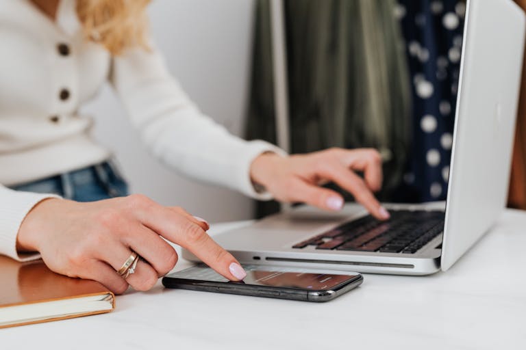 JournalsNewsInfo: Transforming Digital Journalism and Information Access JournalsNewsInfo: Transforming Digital Journalism and Information Access Close-up of a woman's hands using a laptop and smartphone simultaneously on a desk.