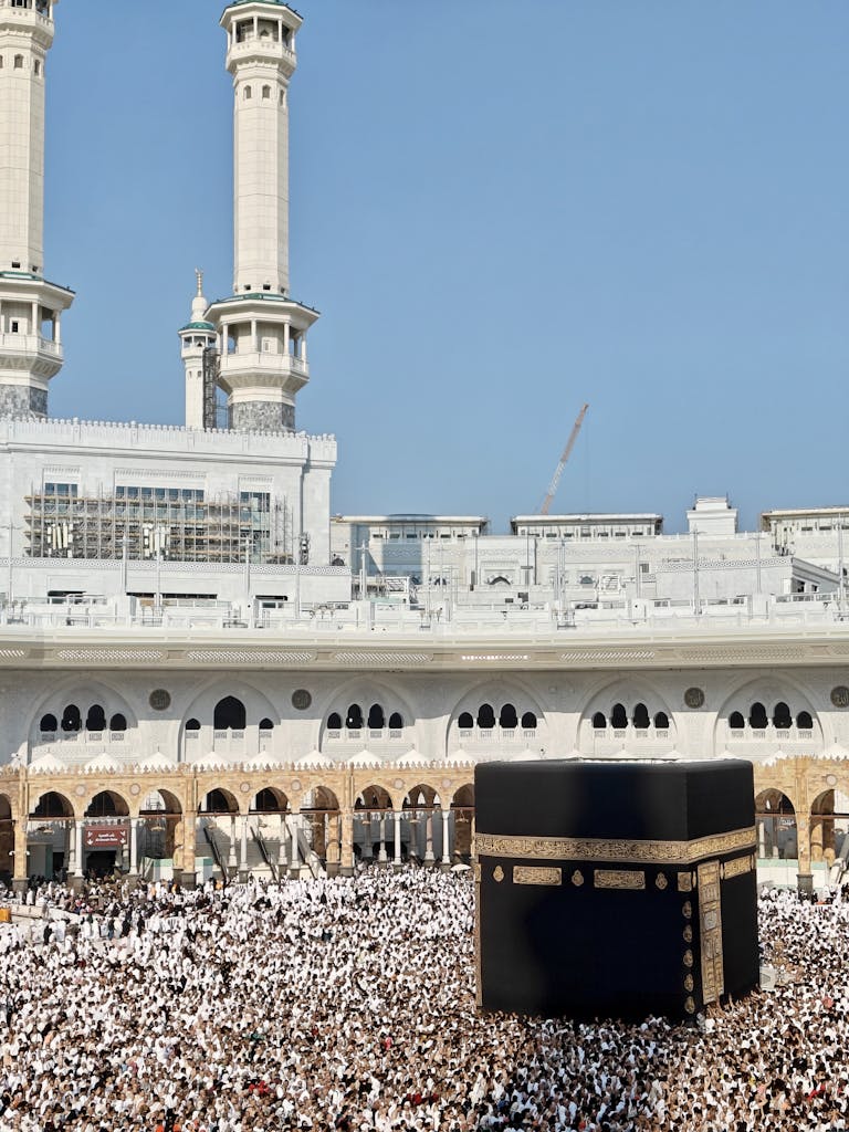 Thousands of worshippers gather at the Grand Mosque in Mecca, surrounding the sacred Kaaba.