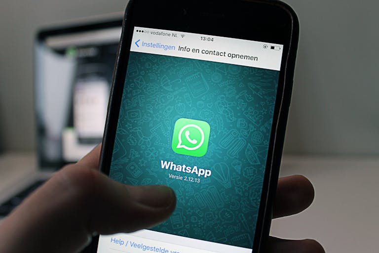 Sotwe: A Comprehensive Guide to the Platform, Features, and ApplicationsA smartphone displaying the WhatsApp application screen held by a person.