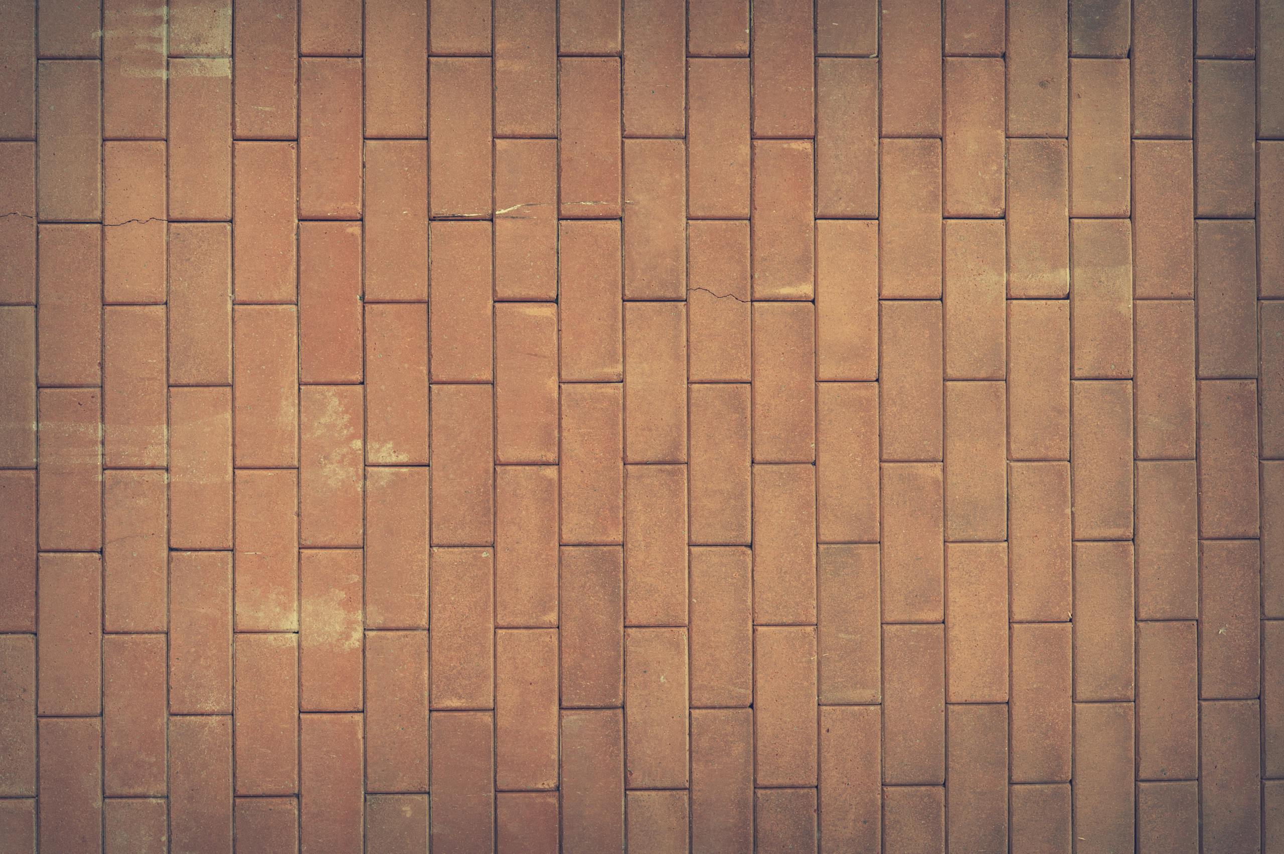 Sixmagazine ventsMagazine A vintage red brick wall texture serves as a classic background with rich earthy tones.
