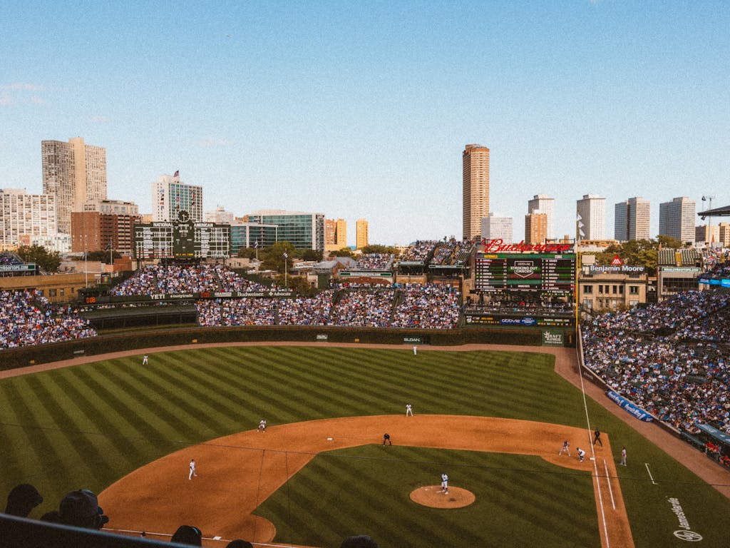 Chicago Cubs  Aerial view of a lively baseball game at a famous stadium with city skyline.