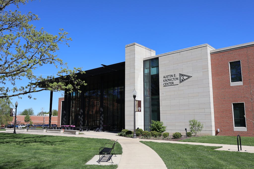 Bright sunny view of the Austin E. Knowlton Center building exterior in Berea, Ohio, surrounded by green lawns and trees.