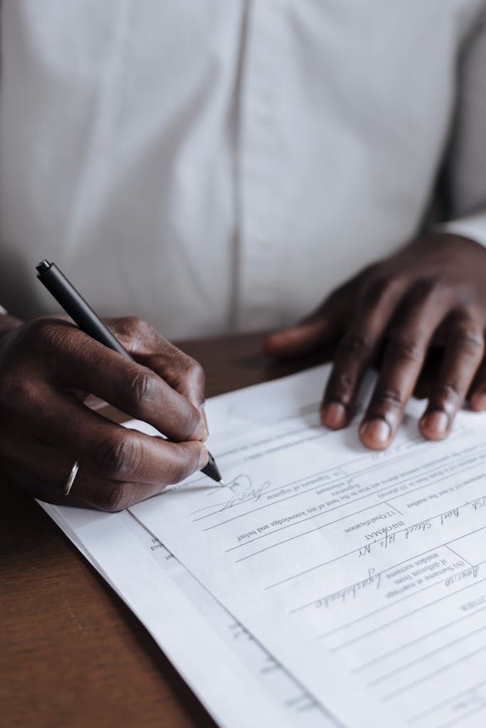ibomma1.com Complete Guide, Features, Legal Risks, and Safe AlternativesClose-up of a man signing legal documents at home, emphasizing responsibility.