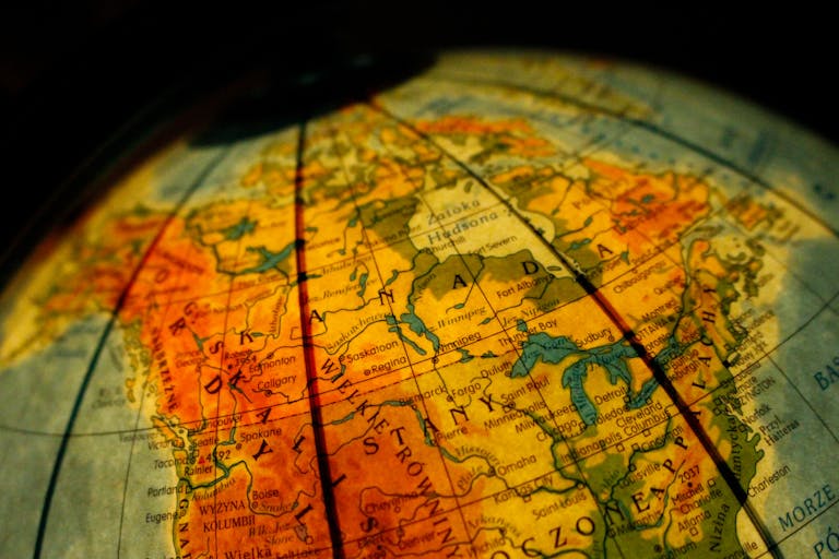 The Globe and Mail Close-up of a vintage globe focusing on Canada and the USA with a warm tone.