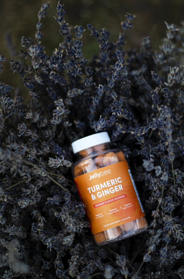 H1: Herbciepscam The Ultimate Guide to Avoiding Herbal Supplement ScamsClose-up of turmeric and ginger gummy bottle surrounded by dry lavender, emphasizing natural health.