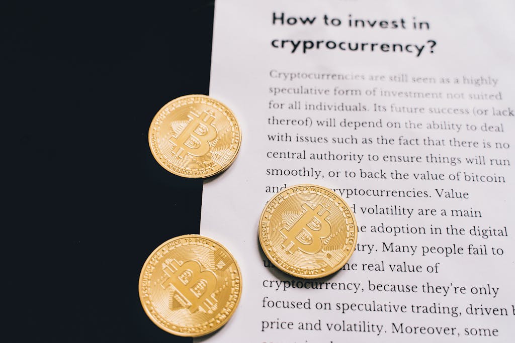 Edivawer Gold Bitcoin coins on top of a cryptocurrency investment guide. High-quality finance and cryptocurrency image.