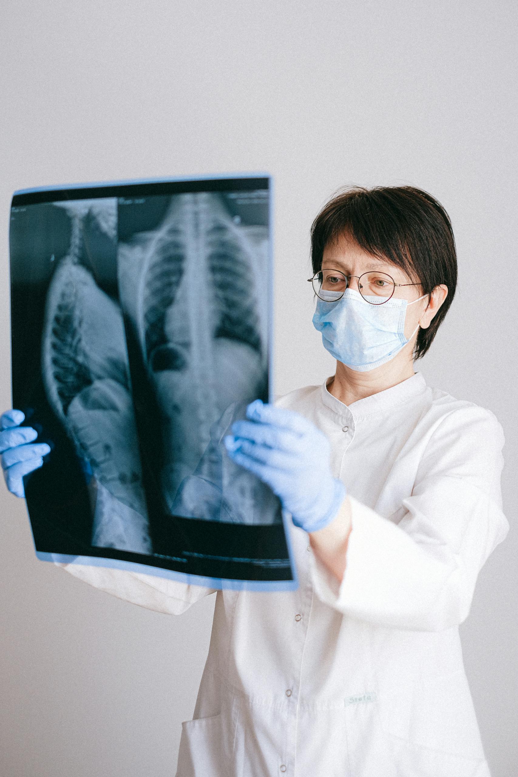MMSBRE: A Comprehensive Guide 2026 Introduction Medical professional in PPE examining chest X-ray results for diagnosis.