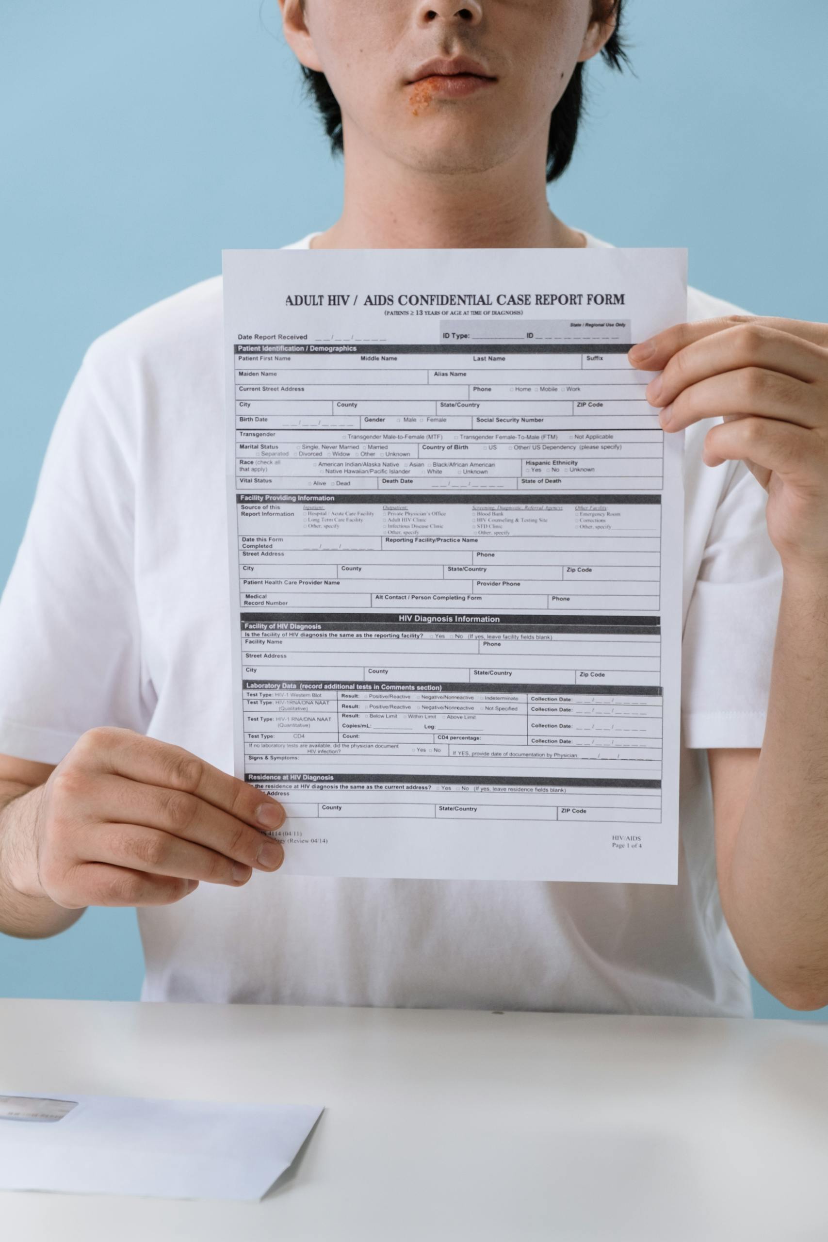 Bolly4u Me The Complete Guide (Legal, Safety & Alternatives) 2026Person holding a confidential HIV/AIDS case report form in a controlled setting, emphasizing health awareness.