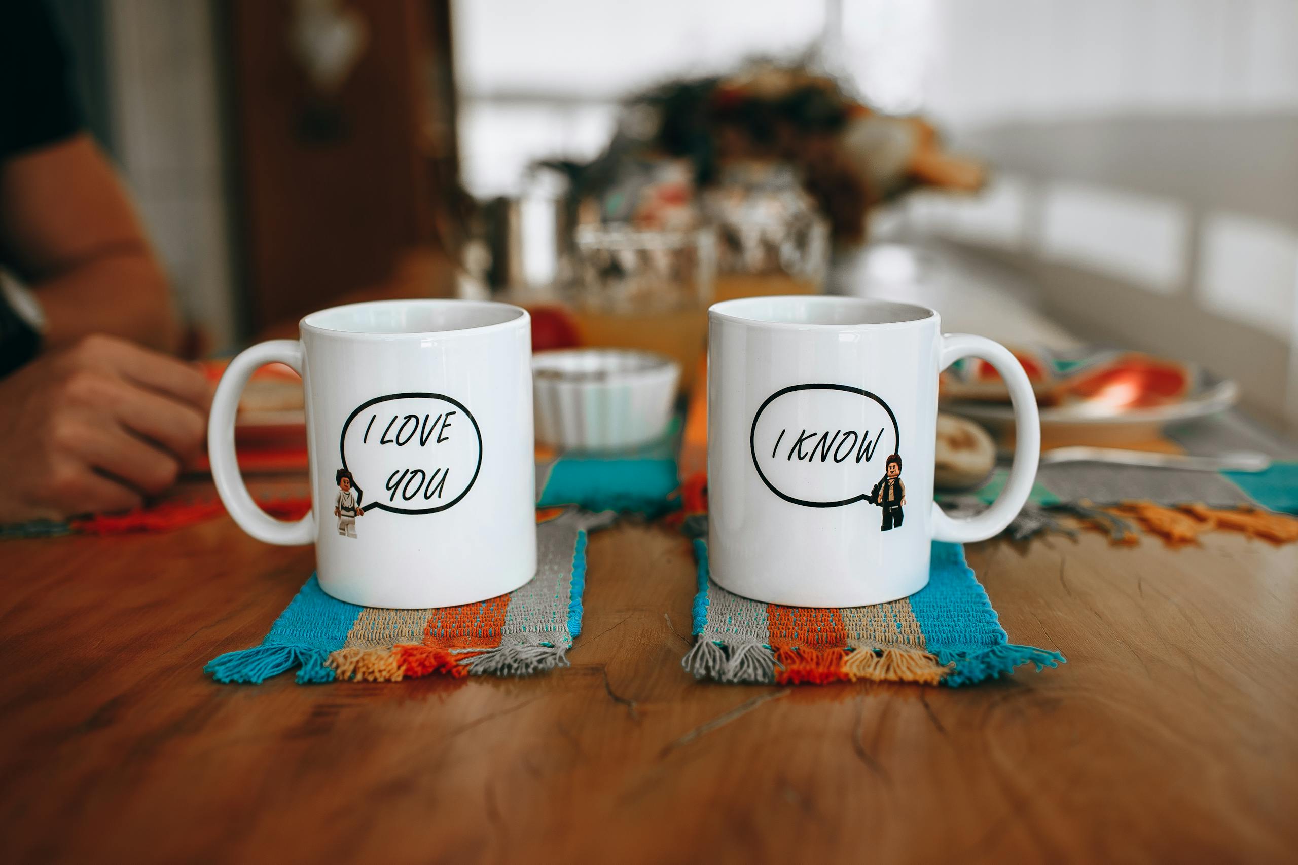 Sodiceram Two mugs with playful text on a table showcasing a cozy indoor setting.