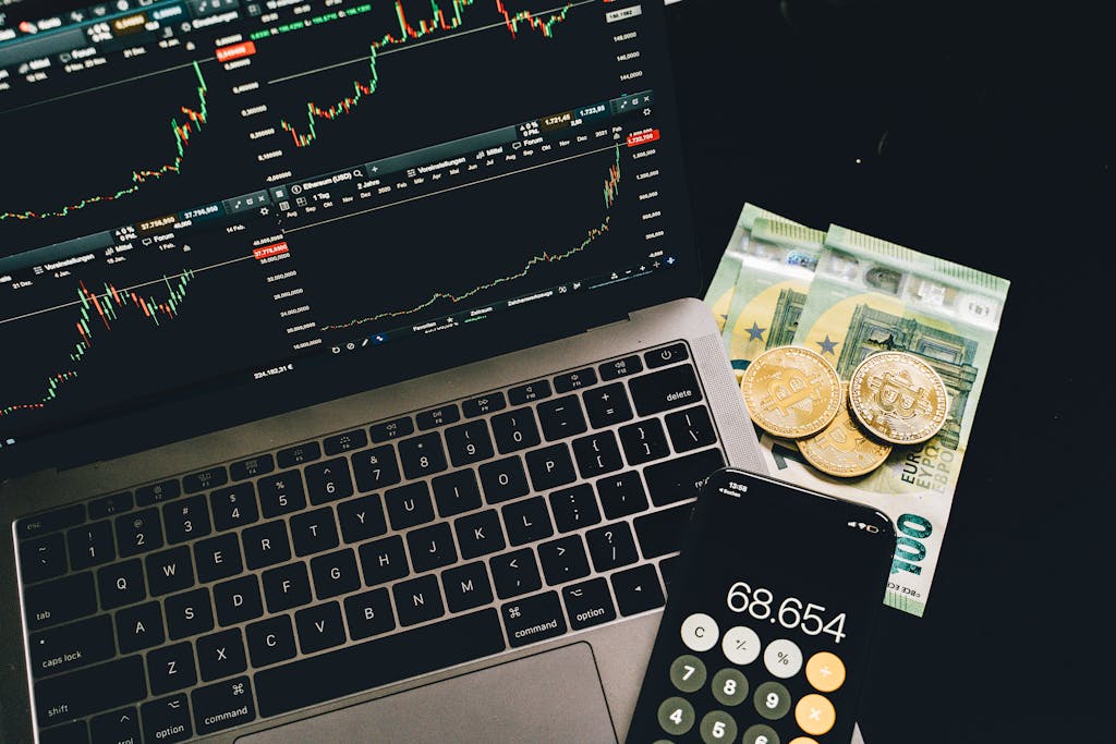 5StarsStocks.com  A Guide to the Stock Research Platform 2026A laptop displaying stock charts with Bitcoin, Euros, and a cellphone calculator, showcasing financial analysis.