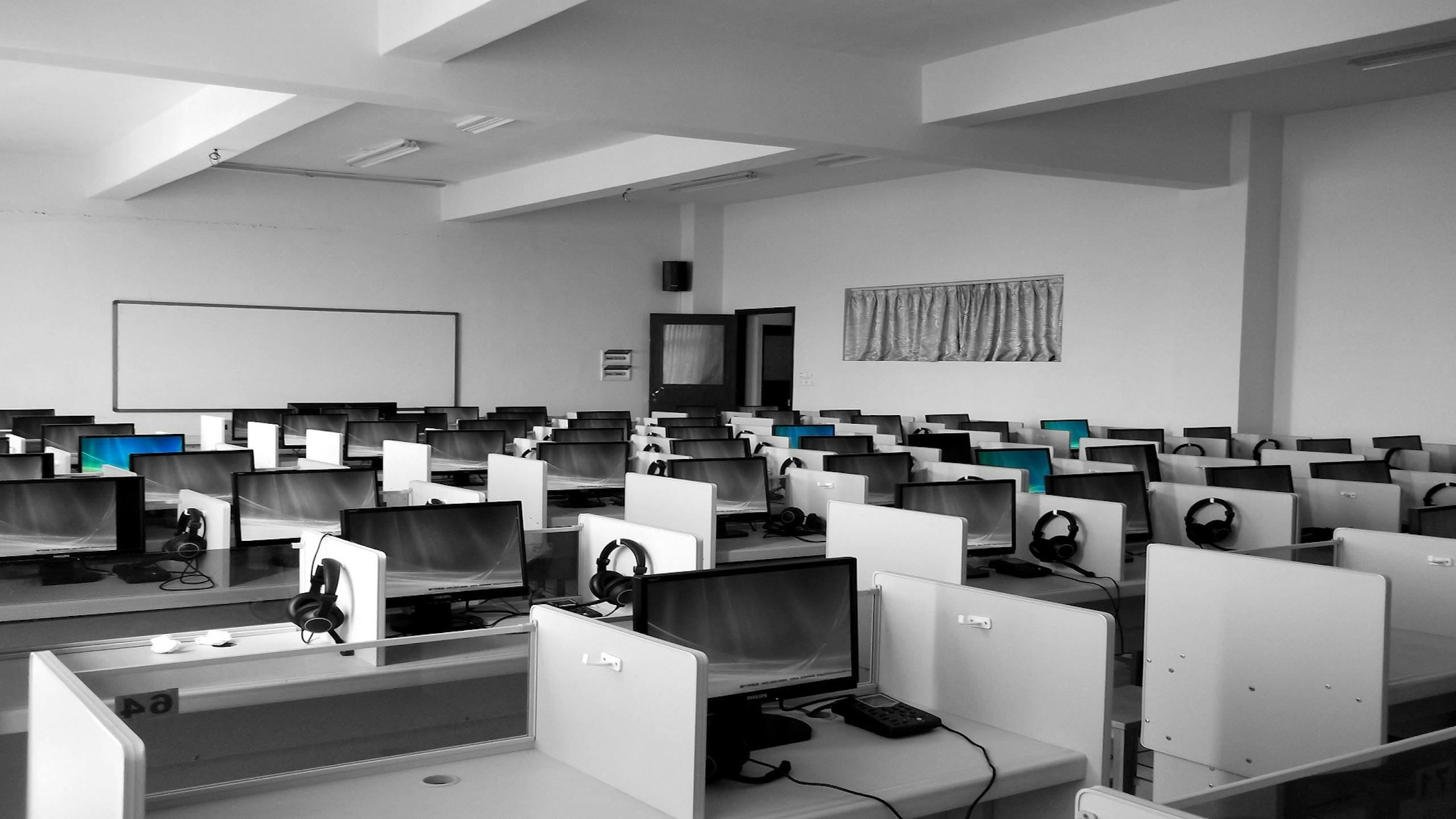 algebra.learning nexus.one spacious, empty call center office with rows of desks and computers, ideal for business environments.