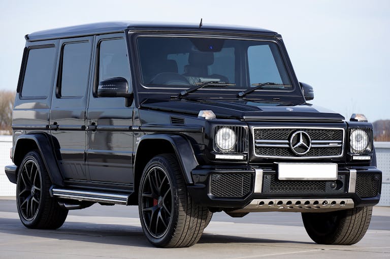 Unbanned G+ black Mercedes G-Class SUV parked outdoors, showcasing luxury design and power.
