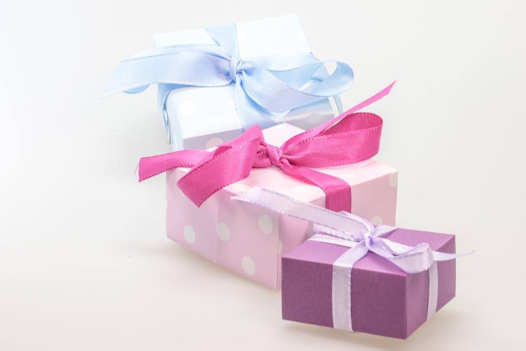 WhatUTalkingBoutWillis Gifts A trio of pastel gift boxes tied with vibrant ribbons, perfect for celebrations.