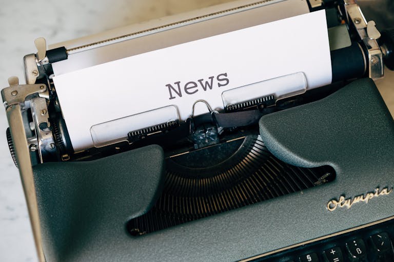 Newscora Close-up of a vintage Olympia typewriter with paper reading 'news'. Perfect for classic journalism themes.