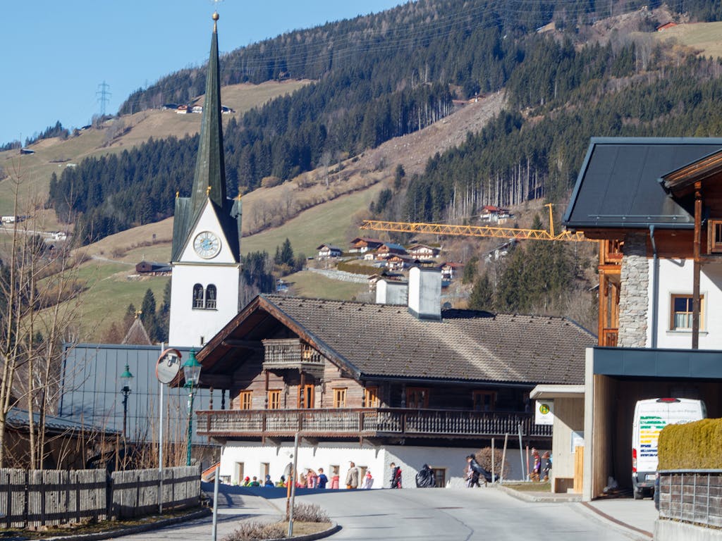 Enntal Picturesque view of an Alpine village with a church steeple and scenic mountain backdrop.